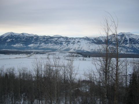 2006 BMW 5 Series - A wide view of a snow-covered valley and distant mountains under an overcast sky.