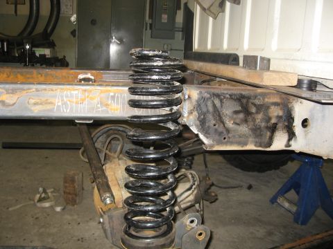 1990 Ford F-250 - Truck frame and suspension spring during a build process.