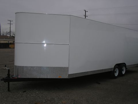 1990 Ford Bronco - This is a white enclosed trailer with a diamond plate front and dual wheels.