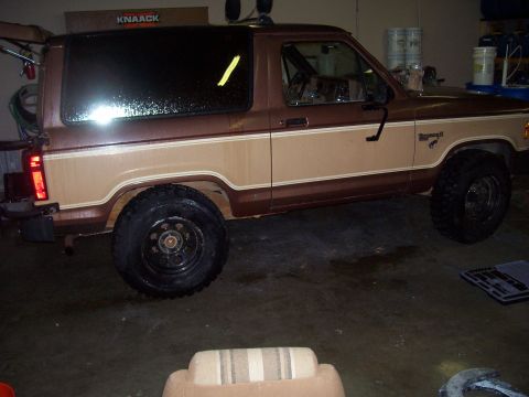 1984 Ford Bronco II - A two-tone brown and tan Ford Bronco II is shown from the side in what appears to be a garage.
