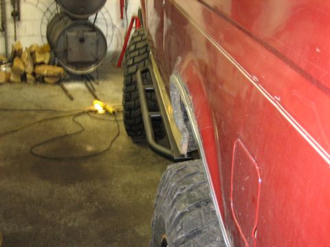1990 Ford Bronco - This 1990 Ford Bronco features custom rock sliders and aggressive off-road tires, visible from its side profile.