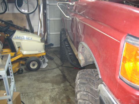 1990 Ford Bronco - Side view of a 1990 Ford Bronco, highlighting the fender, tire, and rock slider.