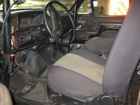 1990 Ford Bronco - Interior view of a 1990 Ford Bronco, the dashboard, steering wheel, and seats.
