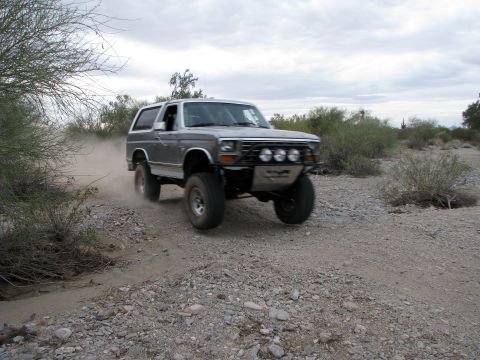 1980 Ford Bronco - This 1980 Ford Bronco is shown off-roading on a dusty dirt path.