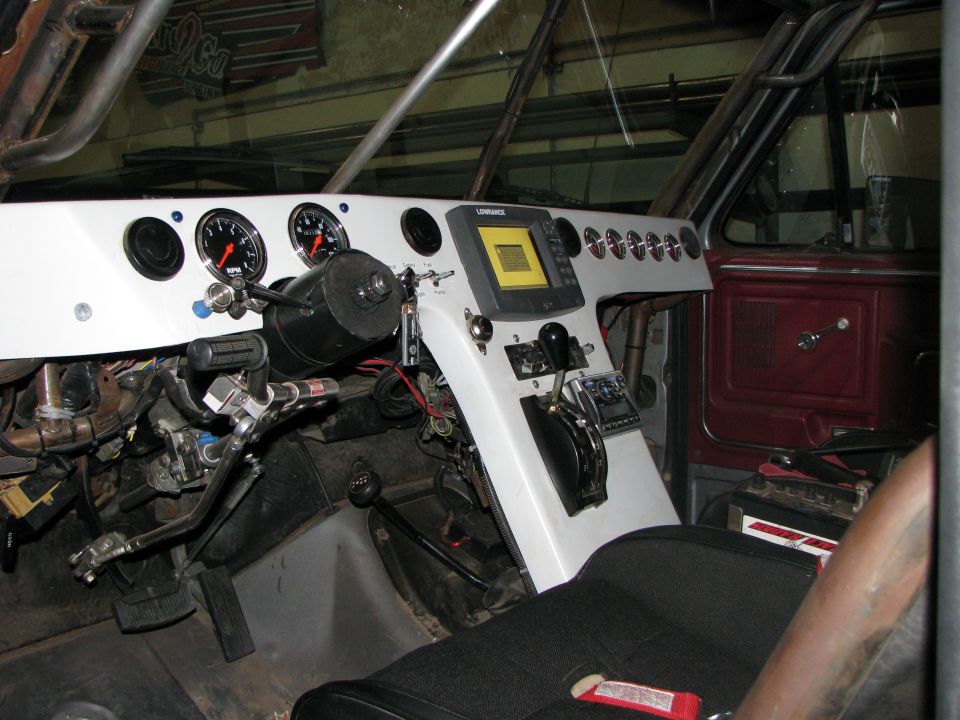 1980 Ford Bronco interior with custom dashboard, gauges, and a GPS unit