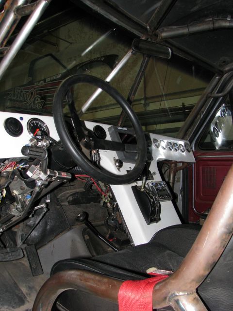 1980 Ford Bronco - Interior view of a modified vehicle, a custom dashboard and roll cage structure.