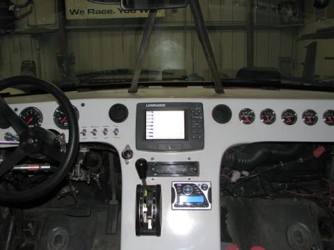1980 Ford Bronco - The interior of a vehicle shows a custom dashboard with navigation and various gauges.