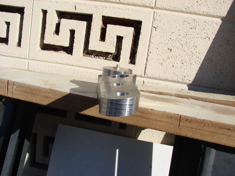Aluminum suspension part with three bolt holes and a central pivot point