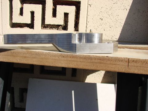 1979 Ford Bronco - A custom-machined metal component is shown resting on a surface.