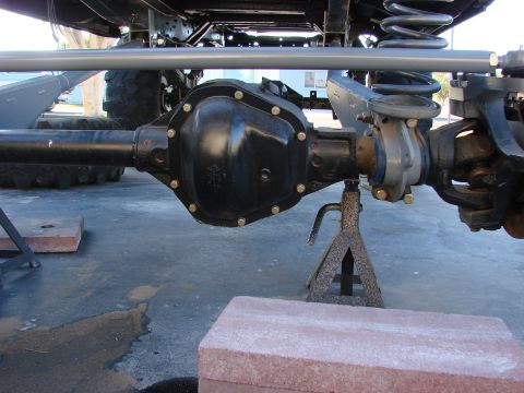 1979 Ford Bronco - Close-up of a vehicle's rear axle assembly, indicating it is undergoing maintenance or modification.