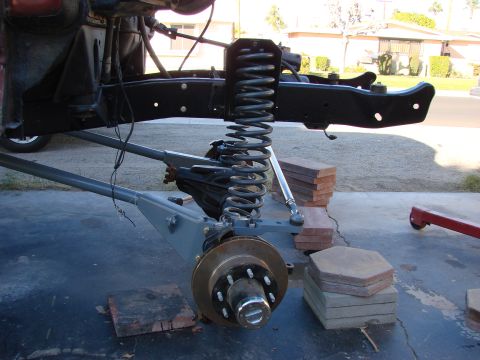 1979 Ford Bronco - Close-up of a vehicle's front suspension system, showing the coil spring and brake components.