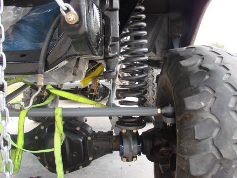 1979 Ford Bronco - Heavy-duty front suspension components and a large tire are visible in this close-up shot.