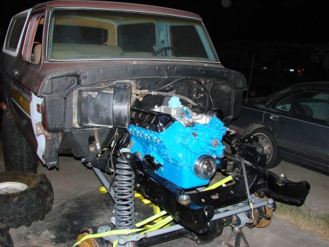 1979 Ford Bronco - Engine bay of a 1979 Ford Bronco during installation of a new blue engine.