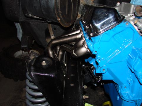 1979 Ford Bronco - Close-up view of an engine installation, highlighting the blue block and chrome headers.