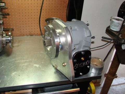 1979 Ford Bronco - A custom NP203/205 doubler transfer case assembly is shown on a workbench, a prominent NWF logo plate.