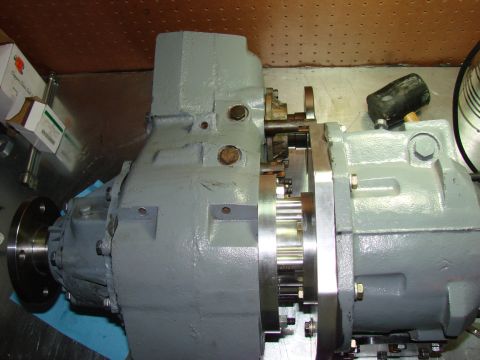 1979 Ford Bronco - A gray NP203/205 doubler transfer case is shown with its adapter plate and gears.