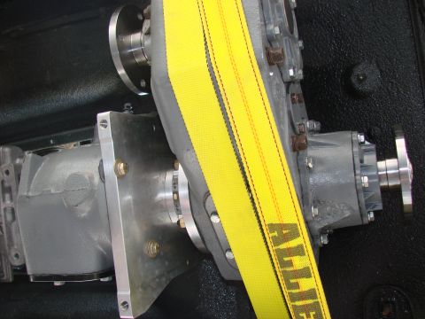 1979 Ford Bronco - Close-up of a transfer case doubler unit, secured with a yellow strap.