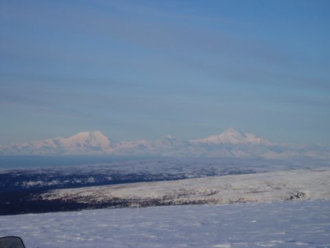 2000 Ford E350 - Expansive view of snow-capped mountains under a bright blue sky, with a vast snowy landscape in the foreground.