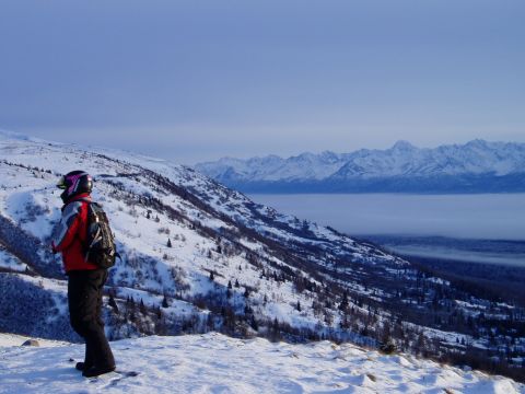 2000 Ford E350 - Winter scene with a person on a snowy mountain overlooking a fog-filled valley and distant peaks.