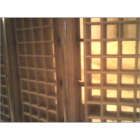 1972 Ford Ranchero - A close-up view of a square-patterned grille, likely a vehicle part.
