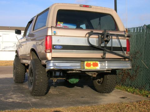 1996 Ford Bronco - This lifted Ford Bronco has a spare tire mounted on the rear and large off-road tires.