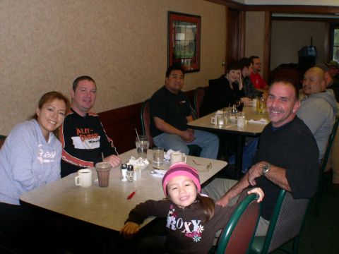 2007 Toyota FJ Cruiser - A group of people are gathered at tables inside a restaurant, with a young child in the foreground.