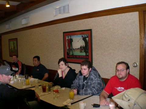 2007 Toyota FJ Cruiser - Group of people dining at tables inside a restaurant with a framed picture on the wall.