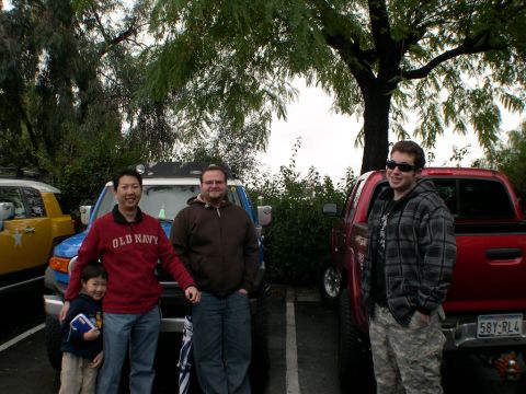 2007 Toyota FJ Cruiser - A group poses with their vehicles, including two Toyota FJ Cruisers and a red pickup truck.