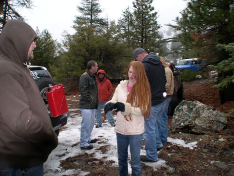 2007 Toyota FJ Cruiser - A group of people stand around two Toyota FJ Cruisers in a snowy, wooded environment.