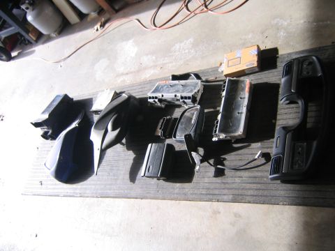1994 Ford Bronco - Various vehicle interior components are displayed on a wooden surface.