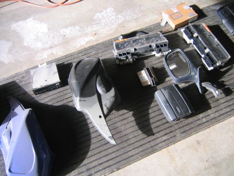 1994 Ford Bronco - Various automotive parts are displayed on a mat, including instrument clusters and a side mirror.