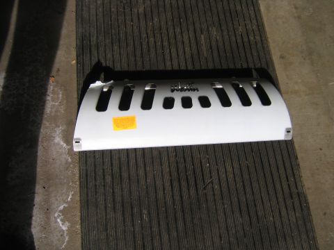 1994 Ford Bronco - A white Westin grille guard is shown lying flat on a ribbed surface.
