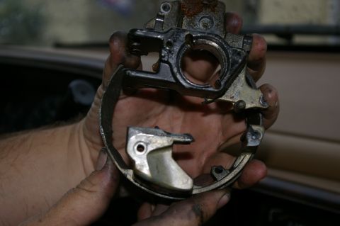 1986 Ford Bronco - Disassembled brake caliper part held in hands, showing mechanical components.