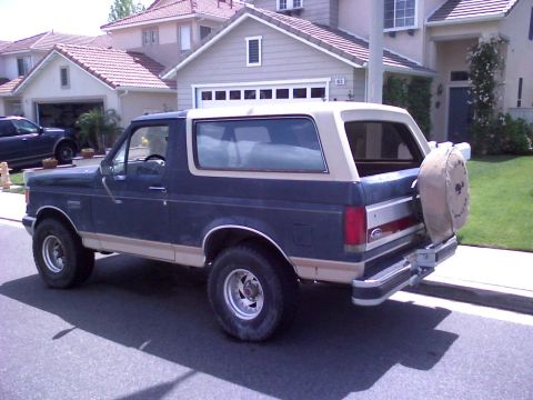 1986 Ford Bronco - This Ford Bronco is parked in front of a suburban house with a two-car garage.