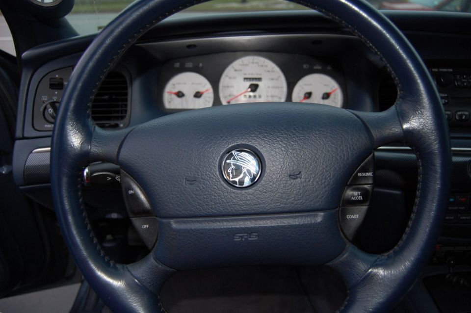 Blue leather steering wheel and dashboard gauges of a 2003 Mercury Grand Marquis