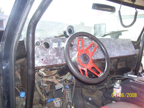 1978 Ford Bronco - Custom interior features a red steering wheel and a metal dashboard with multiple gauges and exposed wiring.