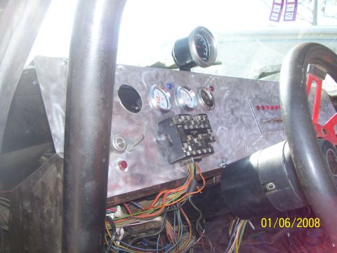 1978 Ford Bronco - The interior features a custom dashboard with multiple gauges and a prominent fuse box, surrounded by extensive wiring.