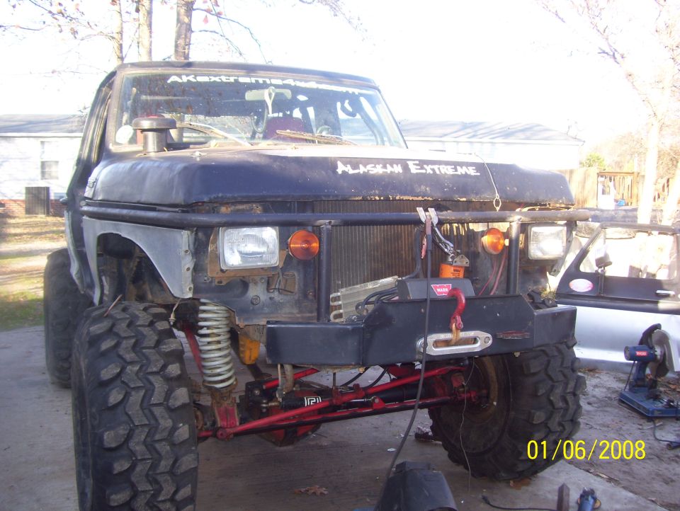 Front view of a heavily modified off-road vehicle with large tires and a winch