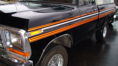 1979 Ford F-150 - This black 1979 Ford F-150 features distinctive orange and silver side accent stripes.
