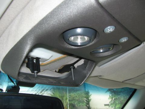 1994 Chevrolet Silverado 3500 - The interior overhead console shows exposed wiring and a light fixture, with a rearview mirror visible below.