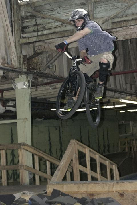 1997 Ford Probe - A BMX rider performs a jump indoors over wooden ramps, with a 'Supermotors.net' logo visible at the bottom.