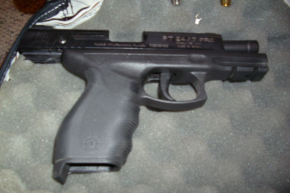 Black Taurus PT 24/7 Pro semi-automatic pistol on carpet