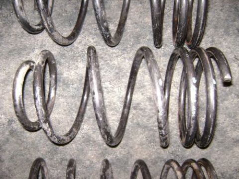 1991 Ford Taurus - Several used coil springs are shown, with some white markings visible on one of them.