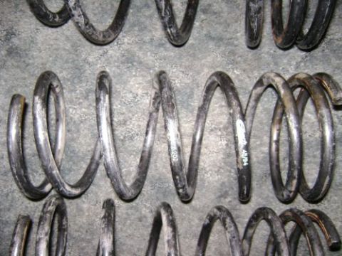 1991 Ford Taurus - Close-up of multiple used coil springs, some showing part numbers and dates.
