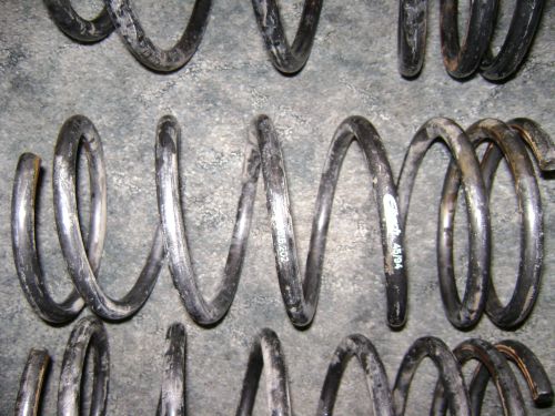 Several used coil springs, some with markings like '45/94'