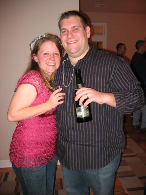 1985 Ford LTD Crown Victoria - A couple poses for a photo at a New Year's Eve party, holding drinks and wearing festive attire.