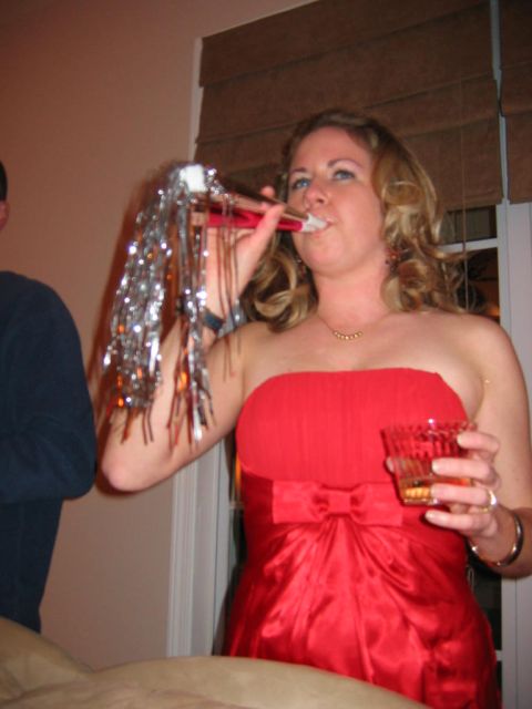 1985 Ford LTD Crown Victoria - Woman celebrating with a party horn and drink.