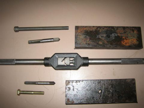 1987 Suzuki Samurai - Tools for cutting threads on bolts and in holes are laid out on a surface.