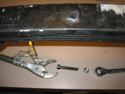 1987 Suzuki Samurai - Tools are laid out next to a leaf spring, ready for suspension work.
