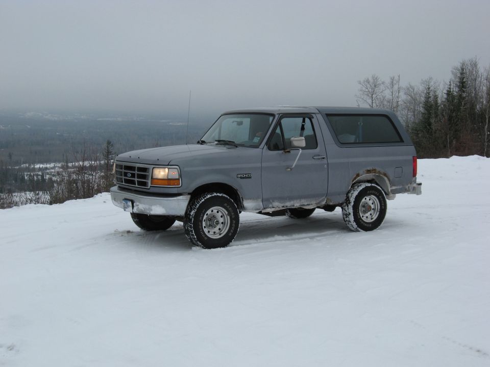 Gray 1994 Ford Bronco parked on a snowy hill